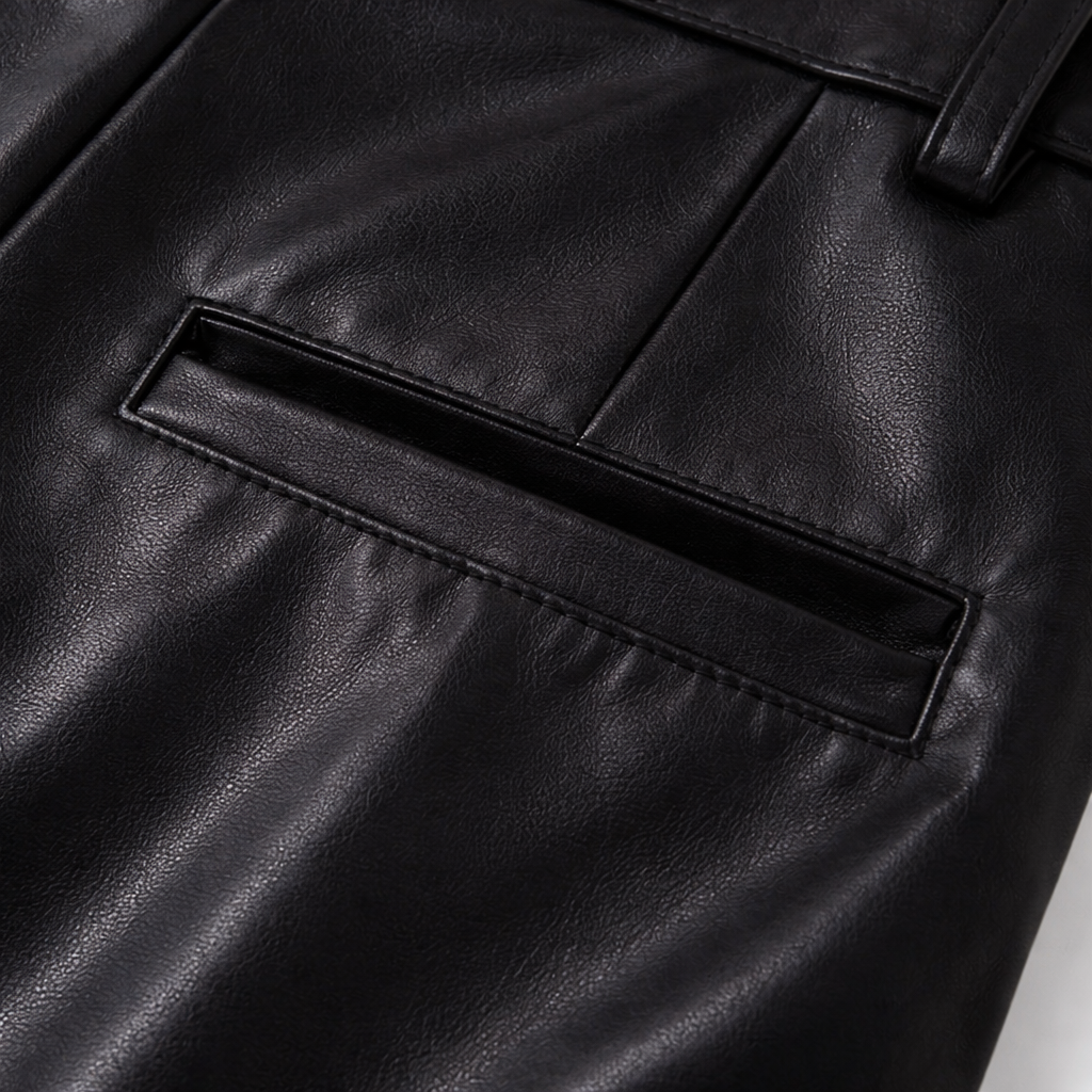 Close-up of the back welt pocket on black leather-look wide-leg pants