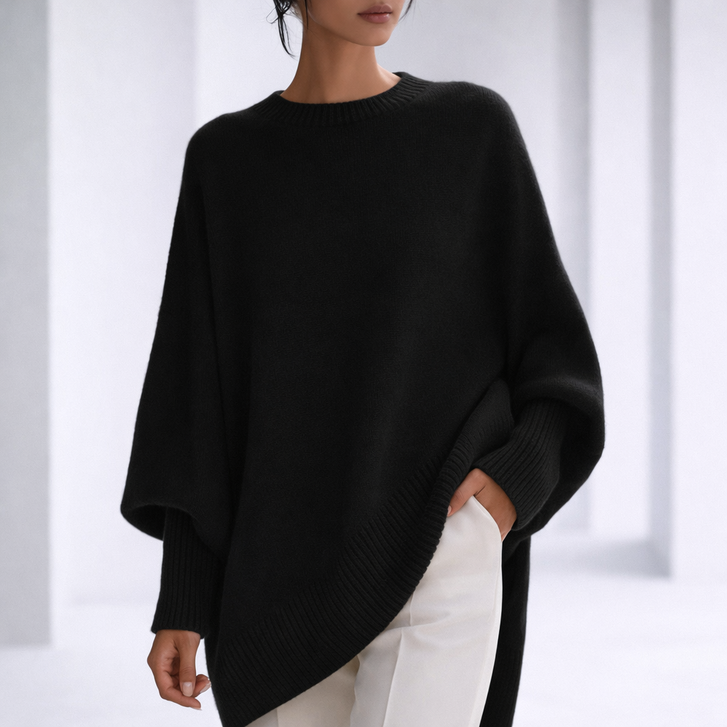 Women's Oversized Crewneck Sweater with Ribbed Cuffs and Hem in Black, worn in a bright studio