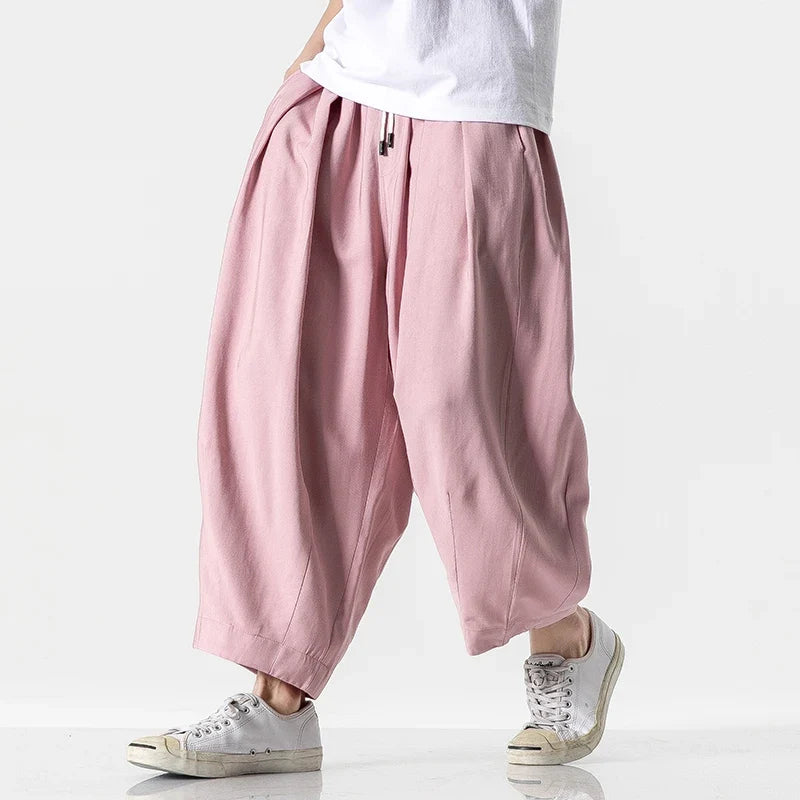 Side view of pink baggy harem pants with cuffed ankles