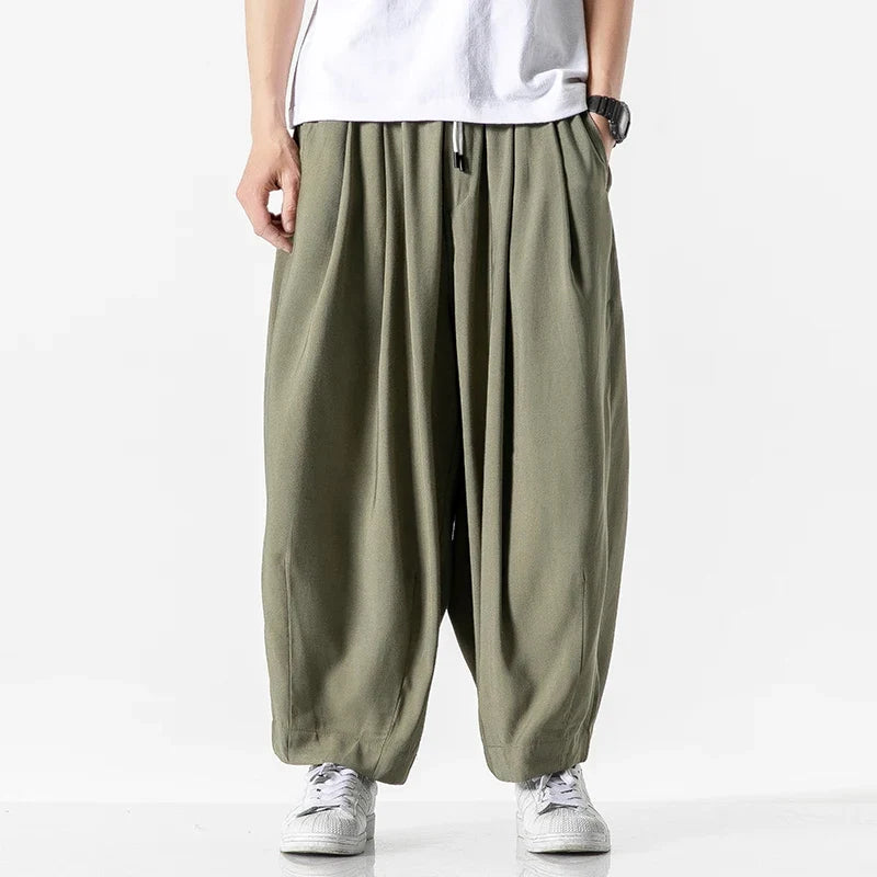 Men's baggy drawstring harem pants in army green, front view