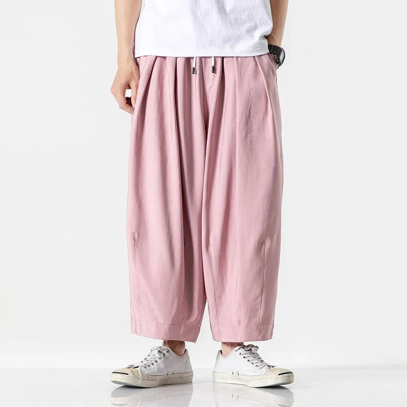 Men's baggy drawstring harem pants in pink, front view