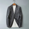 Men's gray corduroy two-button blazer worn open over a white knit shirt