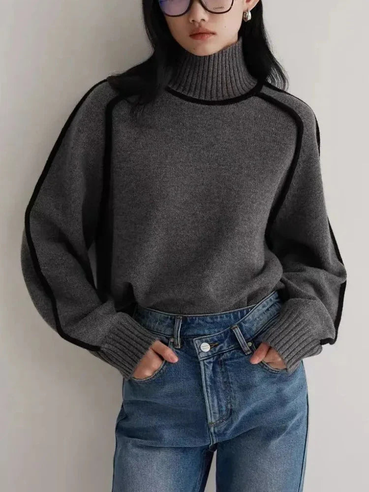 Women's Ribbed Turtleneck Sweater with Contrast Piping in Dark Gray, worn with blue jeans