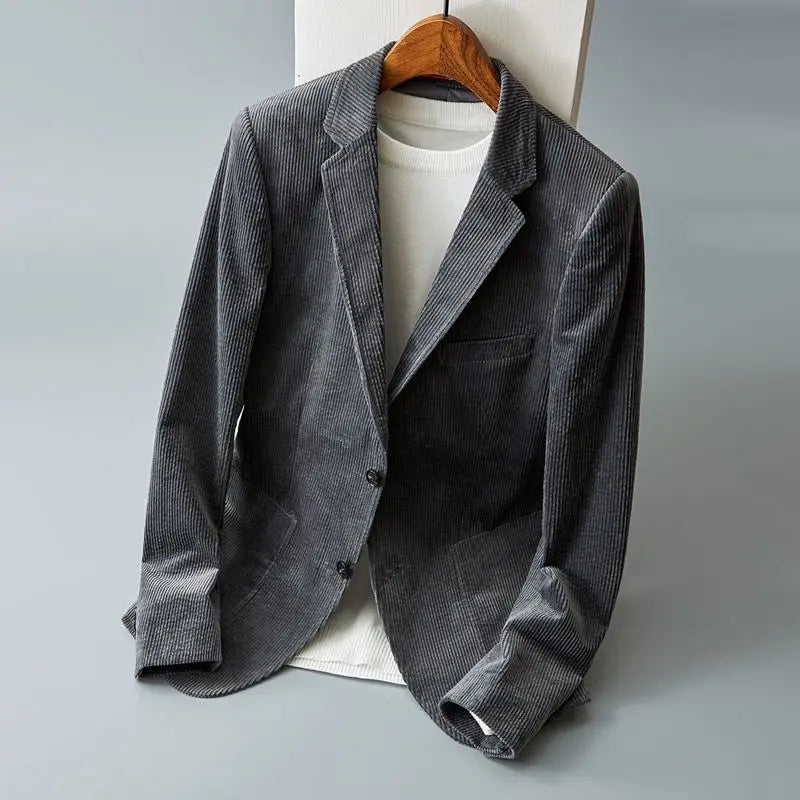 Men's gray corduroy blazer with notch lapels and patch pockets on a hanger