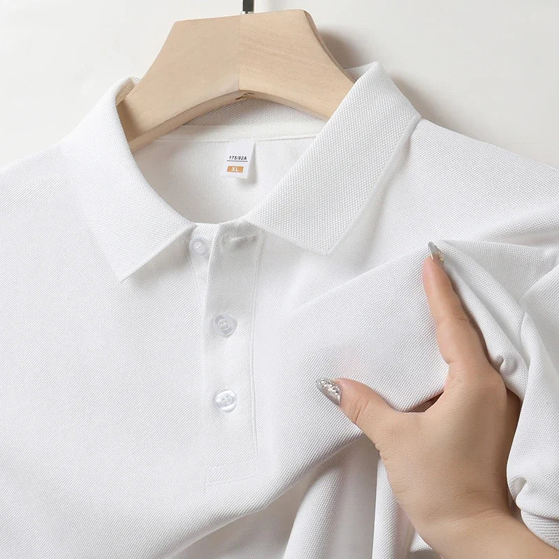 Close-up of the collar and button placket on a men's white textured polo shirt