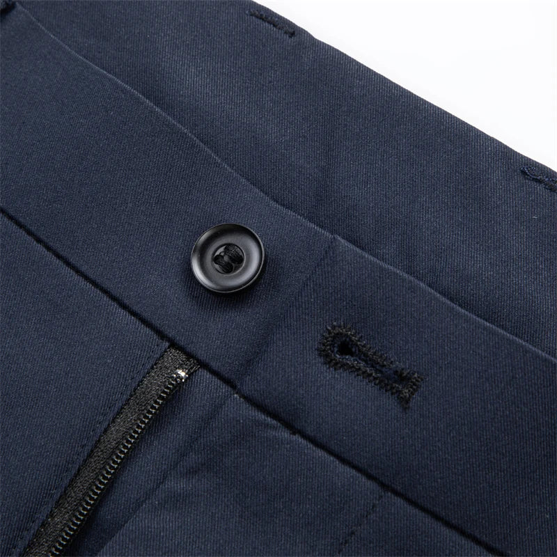 Close-up of button and zip fly on navy dress pants
