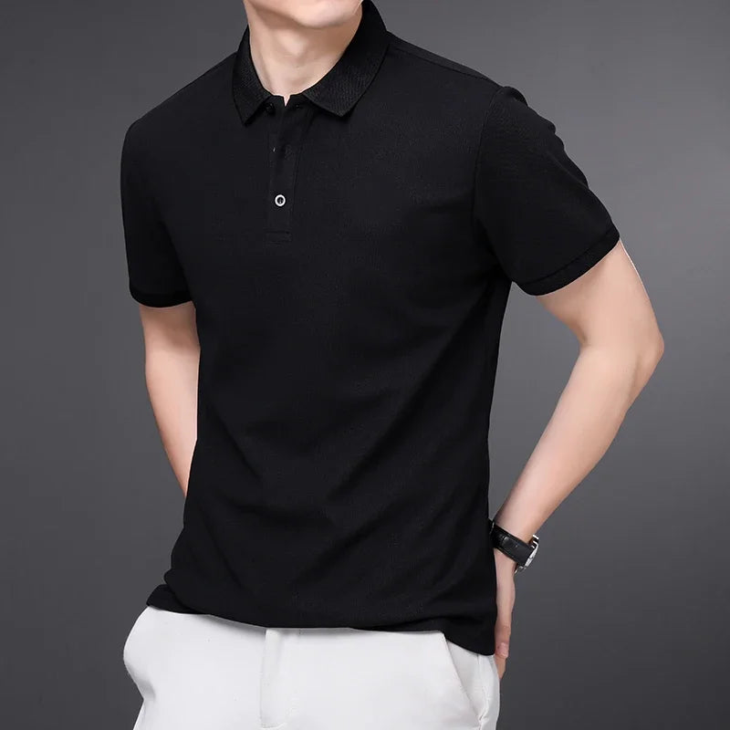 Man wearing a black textured knit polo shirt with short sleeves