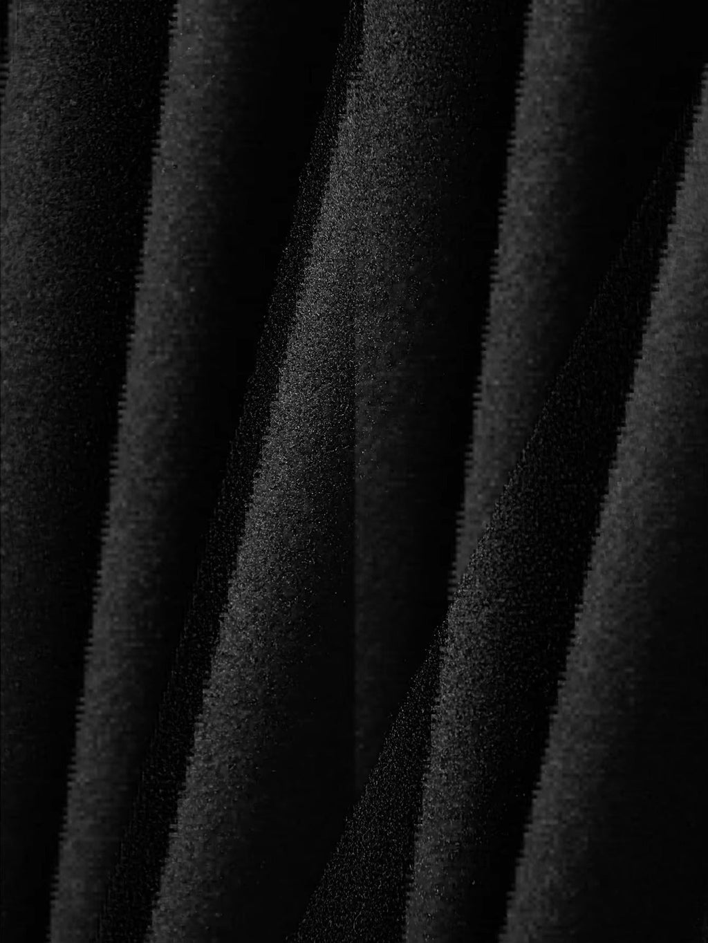 Close-up of brushed black fabric texture on trucker jacket