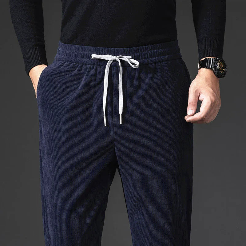 Close-up of the contrast drawstring waistband on men's blue corduroy pants
