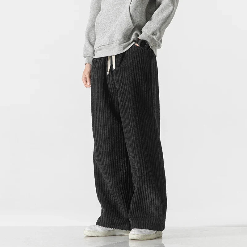 Side view of men's black wide-leg corduroy drawstring pants