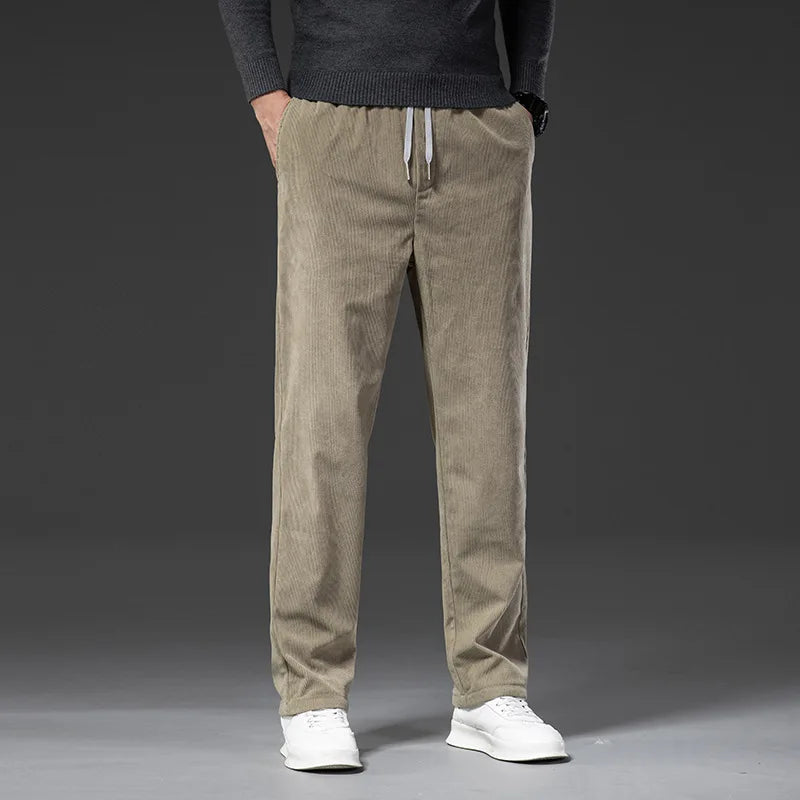 Man wearing khaki corduroy drawstring pants with a straight leg, front view