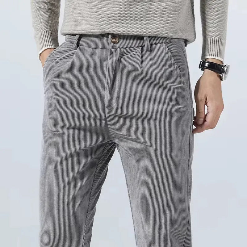 Close-up of button closure on gray corduroy dress pants