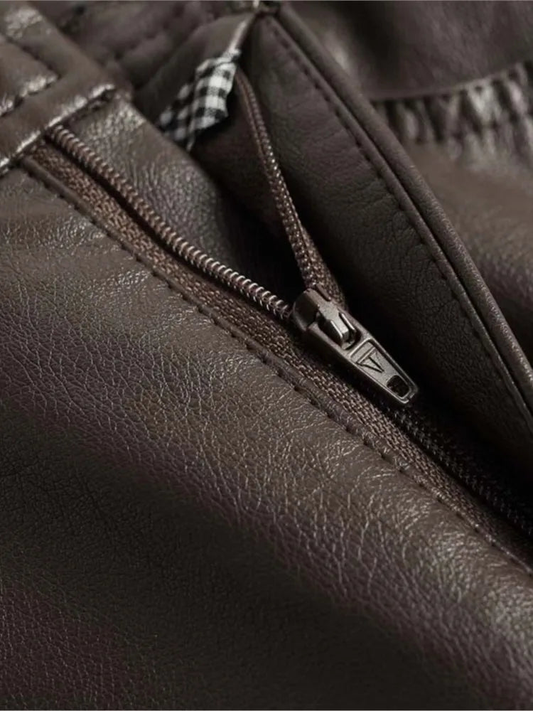 Close-up of zip pocket detail on brown leather-look pants