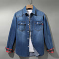 Men's light blue denim shirt with plaid-lined rolled cuffs on a hanger