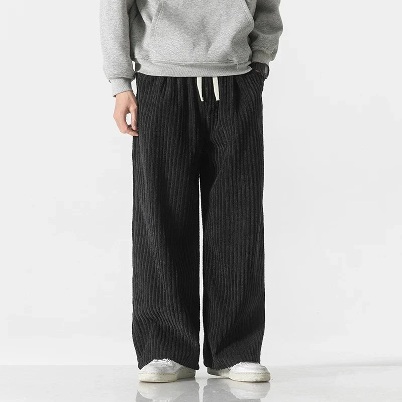Men's relaxed wide-leg corduroy pants in black, front view