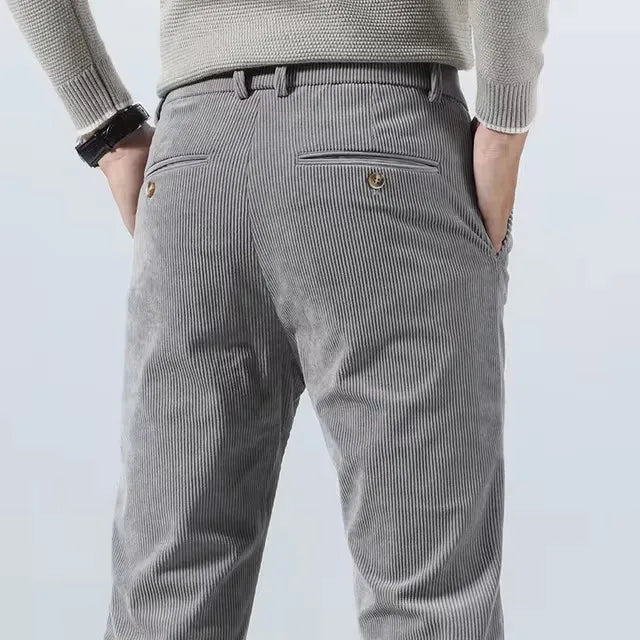 Back view of gray corduroy pants with buttoned back pockets