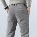 Back view of gray corduroy pants with buttoned back pockets