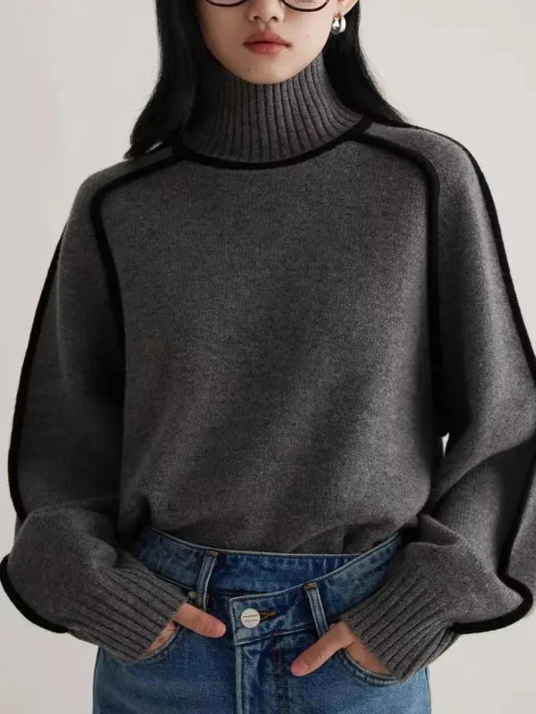 Women's Ribbed Turtleneck Sweater with Contrast Piping in Dark Gray, worn with blue jeans