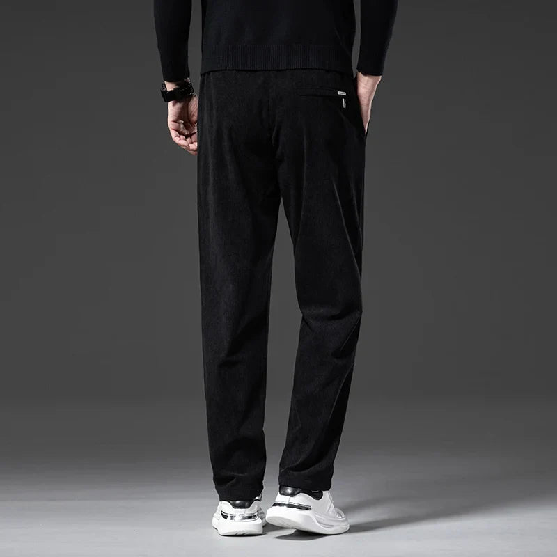Back view of men's black corduroy pants with a zip welt pocket