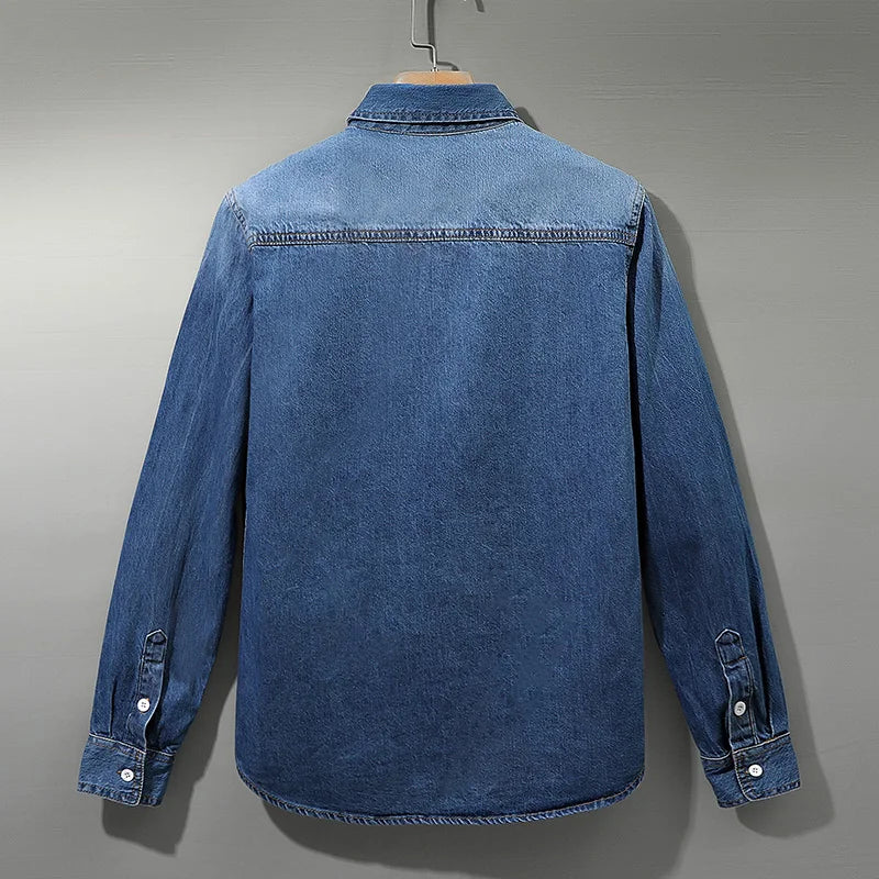Back view of men's light blue denim shirt with yoke seam