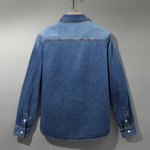 Back view of men's light blue denim shirt with yoke seam