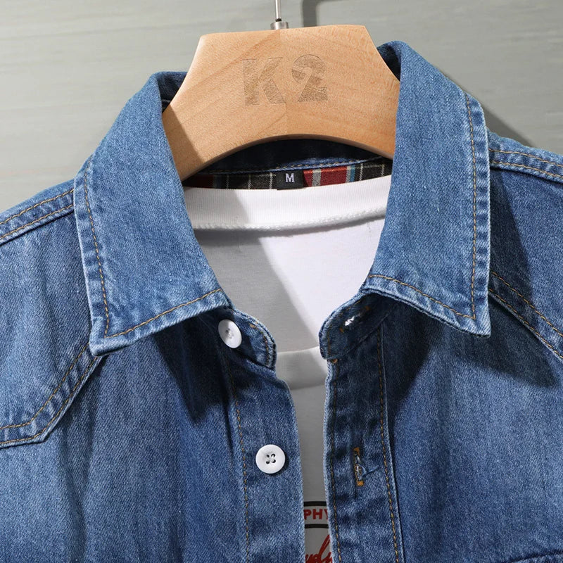 Close-up of collar and plaid inner lining on a denim shirt