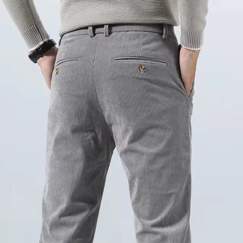 Back view of men's gray slim-fit corduroy pants with buttoned welt pockets