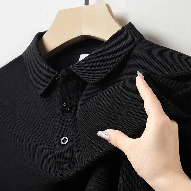 Close-up of the collar and button placket on a men's black textured polo shirt