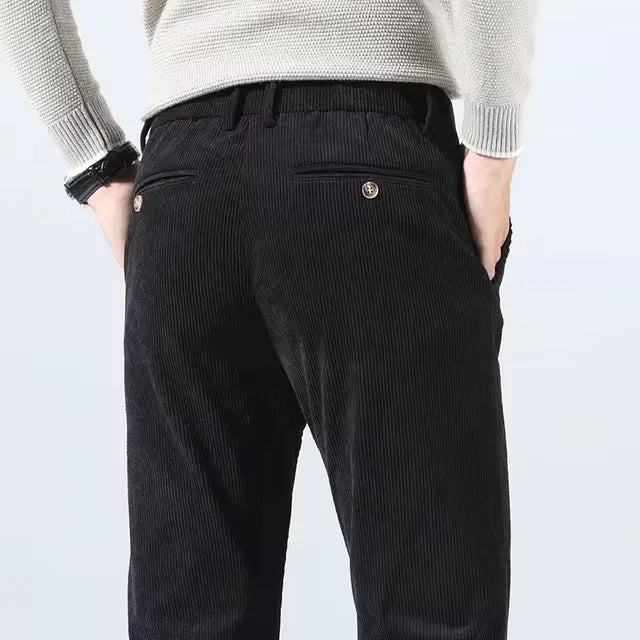 Back view of black corduroy pants with buttoned back pockets