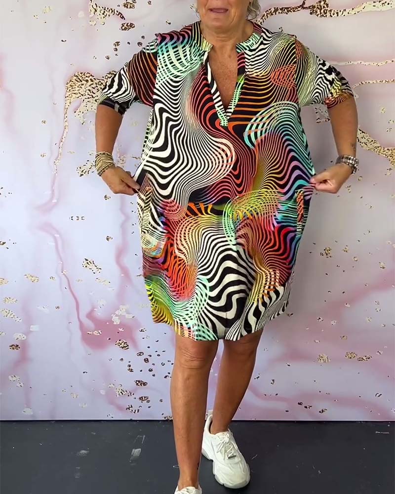 Women's multicolor op-art print shift dress with V-neckline, hands at sides