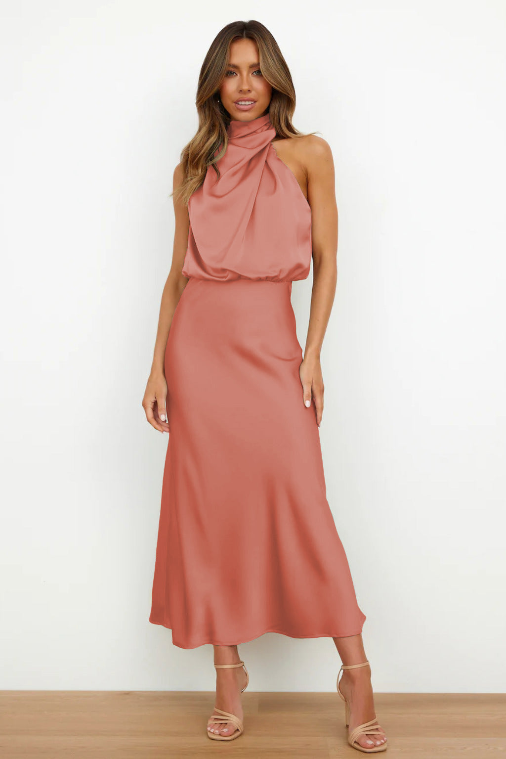 Women's Sleeveless Satin Halter Neck Midi Dress in Coral Pink, on model