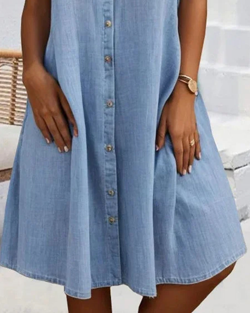 Close-up of button placket and A-line skirt on a light blue shirt dress