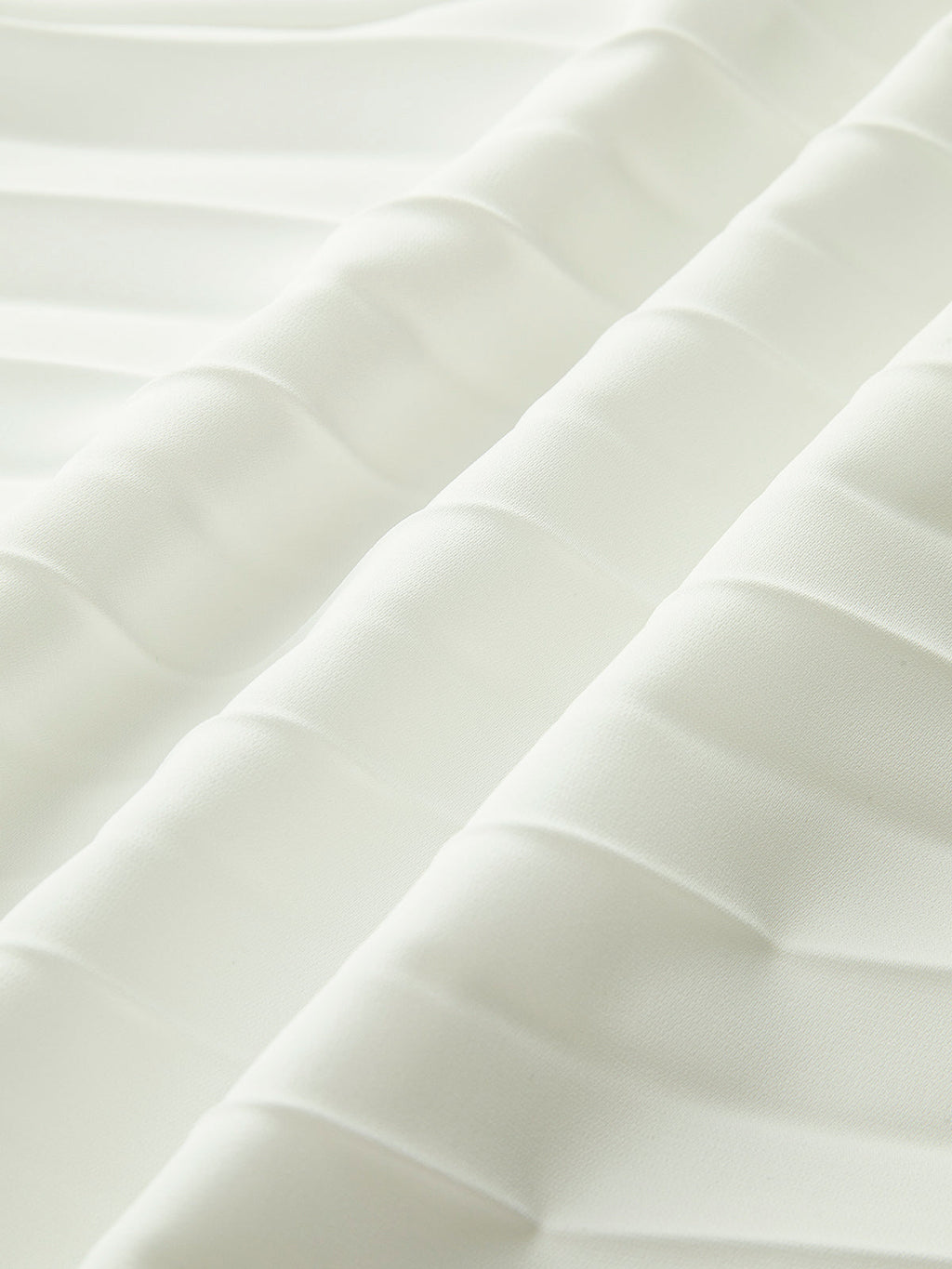 Close-up of the smooth white bodice fabric of the strapless dress