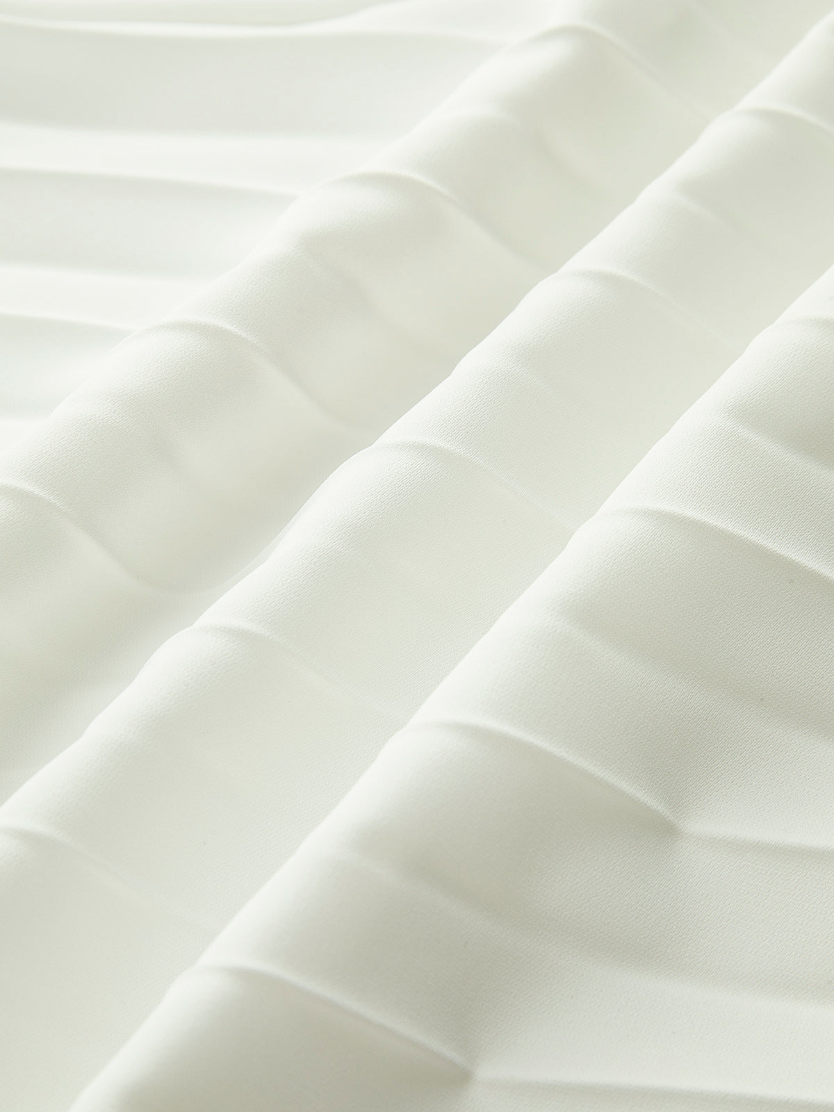 Close-up of the smooth white bodice fabric of the strapless dress
