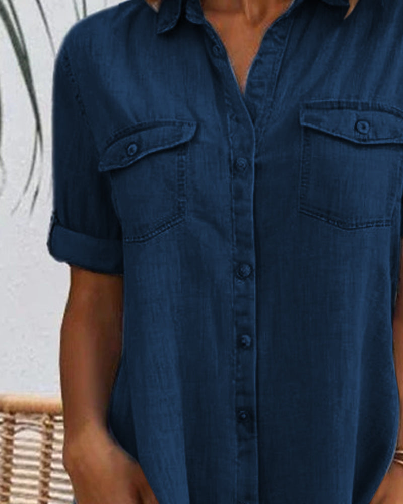 Close-up of chest pockets on a dark blue denim shirt dress