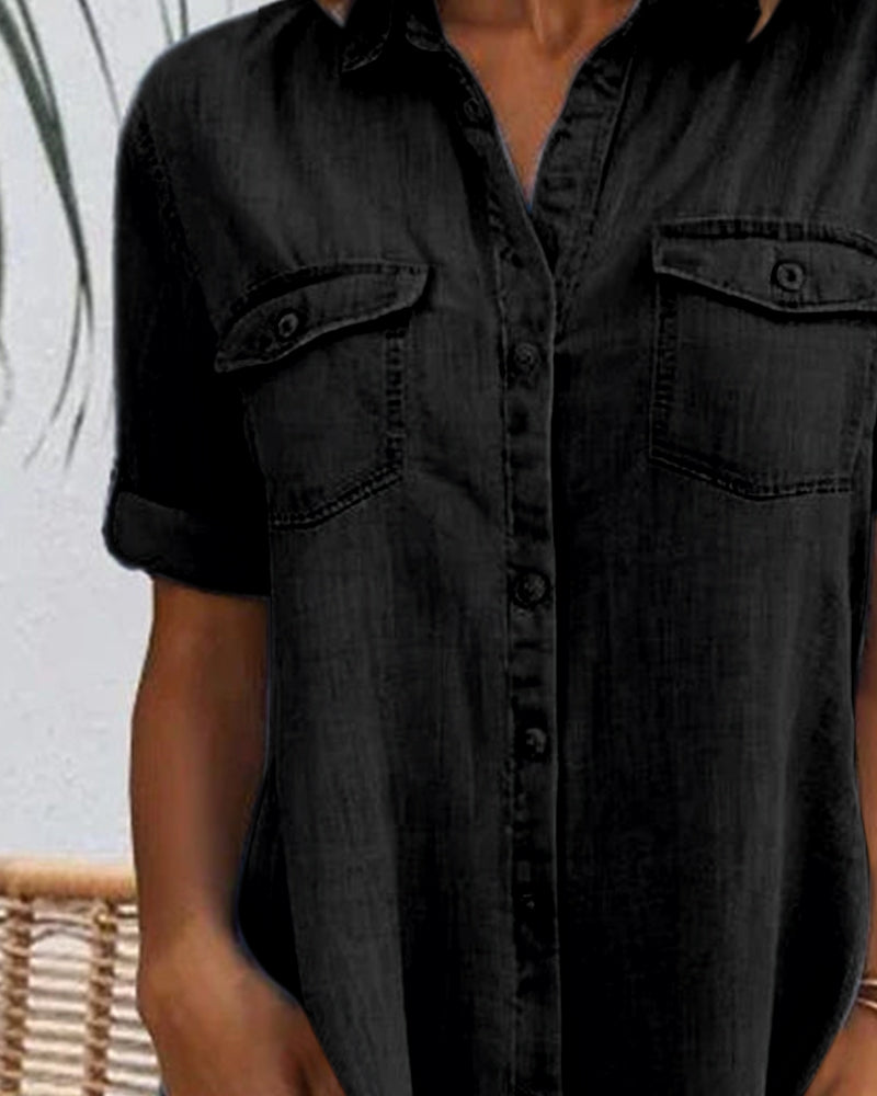 Close-up of chest pockets on a black denim shirt dress