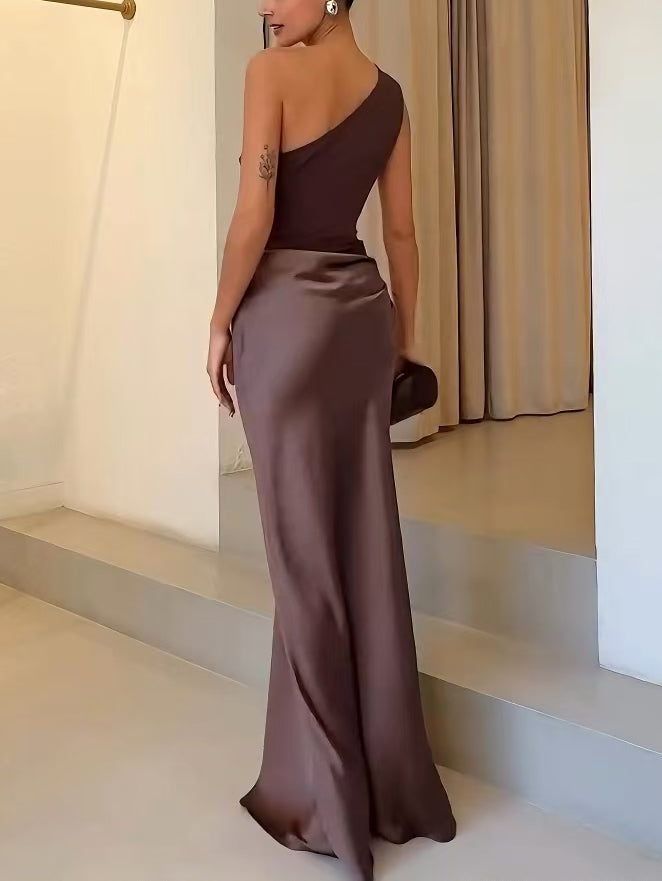 Back view of women's brown one-shoulder maxi dress with flared skirt